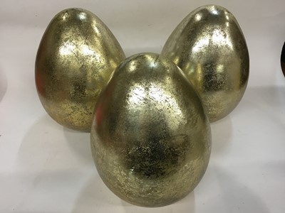 Lot 258 - Three large decorative glass golden eggs