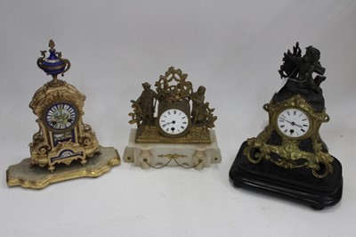 Lot 1883 - Three French mantel clocks, including an ormolu and onyx figural example, an ormolu and spelter cherub clock, and a gilt and porcelain clock