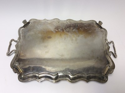Lot 148 - Edwardian silver two handled tray of rectangular form with shaped border and central engraved crest and coat of arms, London 1902, maker Charles Stuart Harris, retailed by Robt. Jones & Son. Liverp...