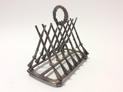Lot 231 - Unusual Victorian silver plated six division toast rack formed with crossed snider rifles and central laurel wreath ring handle, raised on ball feet, with lozenge registration marks, 17cm in length