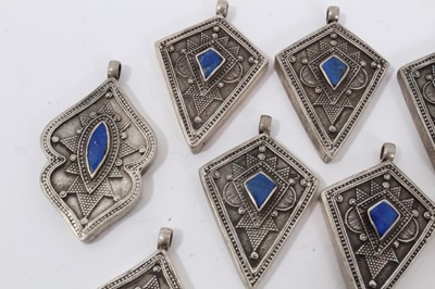 Lot 3 - Collection of 16 Eastern white metal pendants each set with lapis lazuli. Sizes from 3cm to 4.3cm