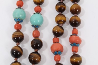 Lot 8 - Two Chinese tiger's eye and coral bead necklaces with white metal panel pendants