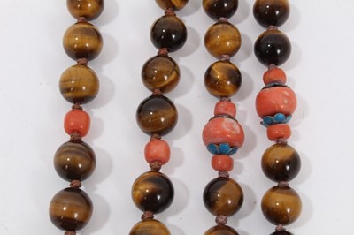 Lot 8 - Two Chinese tiger's eye and coral bead necklaces with white metal panel pendants