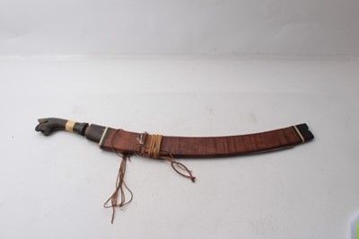 Lot 336 - Two Early 20th century Borneo Parang swords, one with horn and bone hilt , heavy curved blade in horn mounted wood sheath, the other of simple form (2)