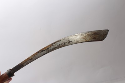 Lot 336 - Two Early 20th century Borneo Parang swords, one with horn and bone hilt , heavy curved blade in horn mounted wood sheath, the other of simple form (2)