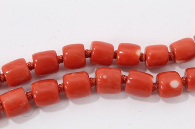 Lot 48 - Old Chinese coral necklace with barrel shaped polished beads and oval silver clasp with wire work flower decoration, 65cm long