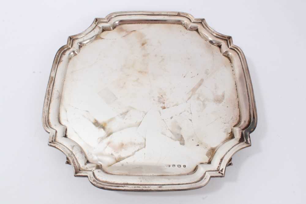 Lot 52 - Silver salver of square form, with shaped corners on four bun feet (Sheffield 1933) by Viner’s Ltd. 30.5cm across