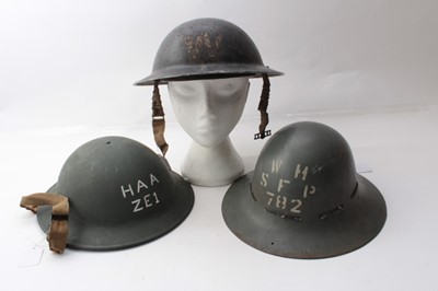 Lot 223 - Second World War Air Raid Wardens Helmet in black painted finish, dated 1940 to interior together with another marked HAA ZE1 and also dated 1940 and a third (3)