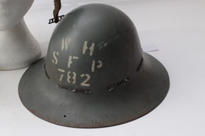 Lot 223 - Second World War Air Raid Wardens Helmet in black painted finish, dated 1940 to interior together with another marked HAA ZE1 and also dated 1940 and a third (3)