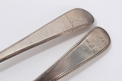 Lot 55 - Pair George III silver beaded Old English pattern tablespoons with engraved crest