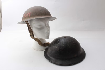 Lot 231 - Second World War British Military MKII Steel Helmet with camouflage painted finish, with chinstrap and liner, dated under brim 1940, together with a Second World War Home Front Bakelite Helmet made...