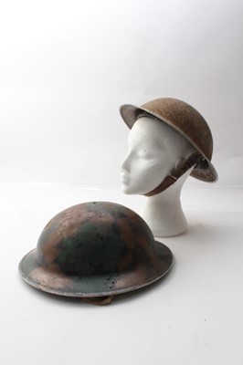 Lot 232 - Second World War British Military MKII Steel Helmet with camouflage painted finish, with chinstrap and liner, together with another similar (2)