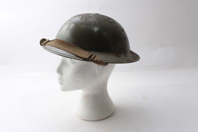 Lot 236 - Second World War British Military MKII Steel Helmet with camouflage painted finish and Gurkha formation  badge to sode, with chinstrap and liner. Dated 1939 under brim