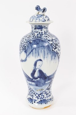 Lot 8 - Pair 19th century Chinese blue and white porcelain baluster vases and cover, decorated with figural panels on a foliate patterned ground
