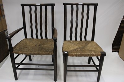 Lot 2038 - 1920s children's rush seated carver chair, together with another similar (2)