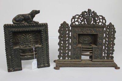 Lot 1894 - Two miniature Victorian ornamental cast iron fireplaces, including one surmounted by Royal Crest and the other by a dog, 29cm and 31cm height