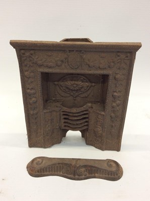 Lot 1895 - Three miniature Victorian ornamental cast iron fireplaces, a cast iron front plate, ash pan front and miniature front (6)