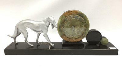 Lot 1942 - Large Art Deco style black marble and onyx clock mounted with a metal dog, 70.5cm width