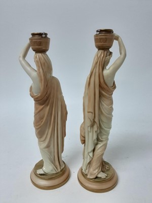 Lot 558 - Pair of Royal Worcester Blush Ivory candlesticks In the form of female water carriers