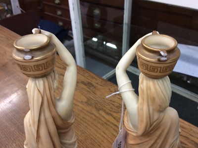 Lot 558 - Pair of Royal Worcester Blush Ivory candlesticks In the form of female water carriers