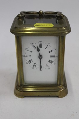 Lot 2009 - Brass carriage clock with white enamel dial and swing handle