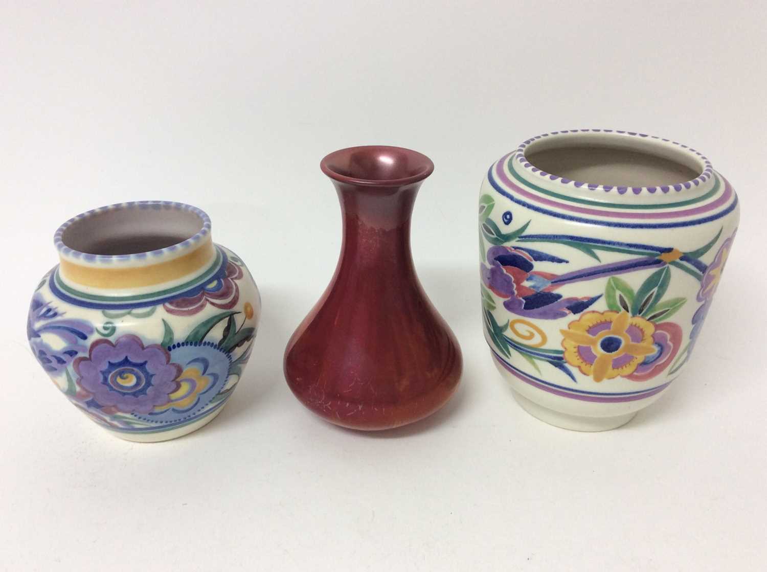 Lot 653 - Carters Poole red lustre vase c.1906 and two bluebird pattern Poole vases, the largest measuring 16cm height (3)