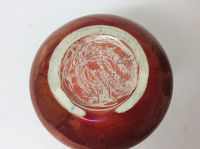 Lot 653 - Carters Poole red lustre vase c.1906 and two bluebird pattern Poole vases, the largest measuring 16cm height (3)