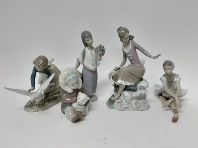 Lot 679 - Five Lladro porcelain figures including eskimo with polar bear, ballerina, girl with flowers etc