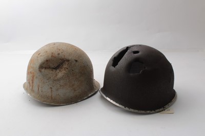 Lot 262 - Second World War American M1 Steel helmet with battle damage, believed to have been found in the Ardennes, together with another American M1 Steel helmet in Desert Camouflage finish (2)
