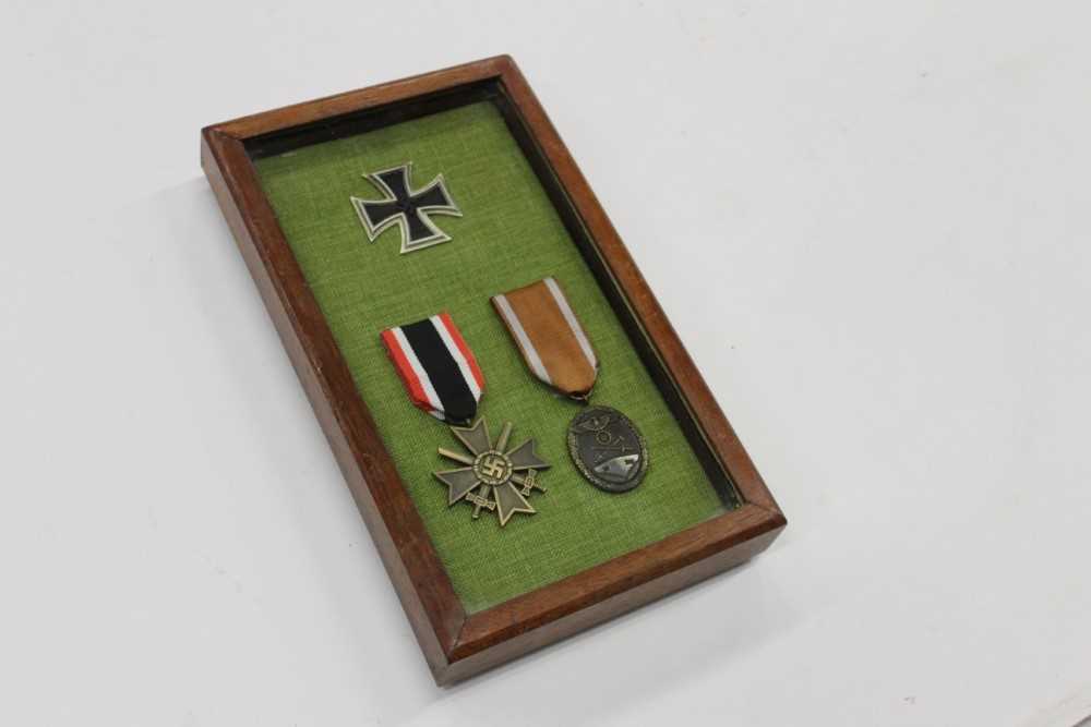 Lot 290 - Group of three replica Nazi German Medals / decorations, mounted in glazed frame, comprising Nazi Iron Cross (First Class), War Merit Cross with Swords and German Defences medal (3)