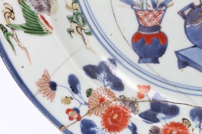 Lot 22 - Early Japanese Edo period Imari dish, c.1700, painted with vases of flowers, further floral patterns, and two phoenixes around the edge, repaired, 32cm diameter