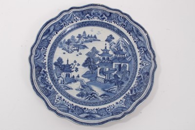 Lot 50 - Fine quality pair of antique 18th century Chinese blue and white porcelain plates, of scalloped form with moulded rims, painted with landscape scenes, 24cm diameter
