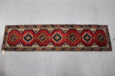 Lot 877 - Anatolian dosemealti runner, with seven stepped medallions on brick red ground, 274 x 68cm