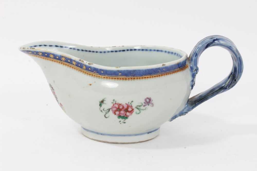 Lot 58 - Antique Chinese famille rose Armorial porcelain sauce boat, c.1800, the armorial at the front with motto reading 'Sit Ordo In Omnibus', the sides with floral sprays, patterned borders and double st...