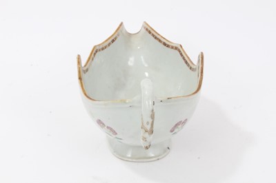 Lot 59 - Antique 18th century Chinese famille rose Armorial porcelain sauce boat, the armorial painted on both sides, the motto faded but appears to read 'Mea Fides Gloria', adorned with floral sprays, 24cm...