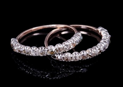 Lot 346 - Pair of Georgian diamond half eternity rings, each with thirteen old cut diamonds in silver collet setting on fluted gold shank, ring size K-K½.