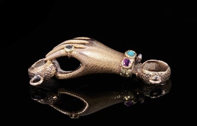 Lot 350 - Regency gold and gem-set clasp in the form of a hand with textured finish, wearing a gem-set ring and bracelet/cuff. 30mm