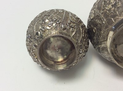 Lot 166 - Pair of late 19th century Chinese silver bottle vases with chased and embossed decoration of prunus, character marks to bases for Wang Hing