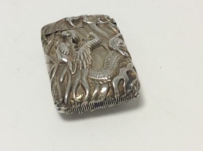 Lot 167 - Chinese white metal vesta case of conventional form with embossed dragon decoration, and hinged cover, 5cm in length