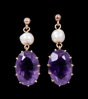 Lot 358 - Pair of amethyst and cultured pearl pendant earrings, each with an oval mixed cut amethyst measuring approximately 13.5-14mm x 9.5mm in gold claw setting suspended from a cultured pearl. Length 25m...