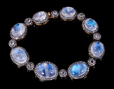 Lot 361 - Moonstone and diamond bracelet with eight graduated oval moonstone cabochons surrounded by single cut diamonds interspaced by eight rose cut and single cut diamond clusters in silver and 18ct gold...