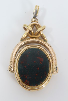 Lot 370 - Unusual late Victorian gold/yellow metal and agate revolving fob with concealed locket compartment, 35mm.