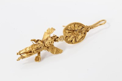 Lot 388 - Antique or possibly ancient gold earring, modelled as Eros or Cupid, the winged figure suspended from a rosette with hook fitting. Possibly Greek Hellenistic period circa 3rd or 4th century B.C. or...