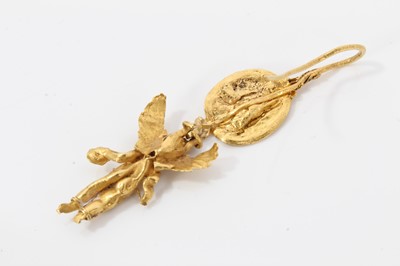 Lot 388 - Antique or possibly ancient gold earring, modelled as Eros or Cupid, the winged figure suspended from a rosette with hook fitting. Possibly Greek Hellenistic period circa 3rd or 4th century B.C. or...