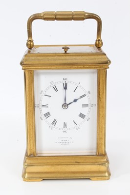 Lot 916 - Late Victorian repeating carriage clock retailed by Dent, 35 Cockspur Street, London, striking on gong  with enamel dial, gilt brass case of small proportions with strike/ silent lever to underside...