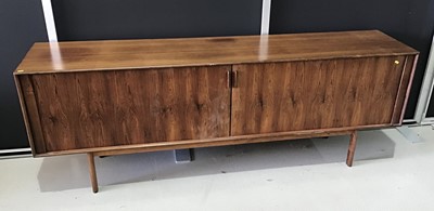 Lot 800 - Large 1970s Danish rosewood (Indian rosewood) sideboard, with interior of shelves and sliding trays enclosed by a tambour shutters, 220cm wide x 48cm deep x 80cm high