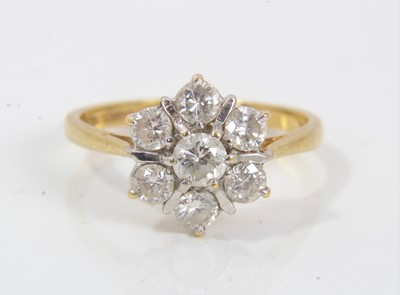 Lot 396 - Diamond cluster ring with a flower head cluster of seven brilliant cut diamonds in claw setting on 18ct yellow gold shank. Estimated total diamond weight approximately 0.75cts. Ring size N