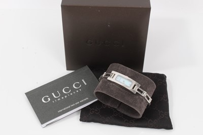 Lot 409 - Ladies Gucci stainless steel bracelet watch with mother of pearl rectangular dial and diamond dot hour markers on articulated stainless steel bracelet with clasp. Model 3900L. In original Gucci box...