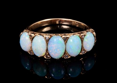 Lot 402 - Late Victorian opal five stone ring with five graduated oval cabochon opals in carved gold setting with diamond accents, carved gold shoulders on plain shank, ring size N½. Opals graduating from ap...