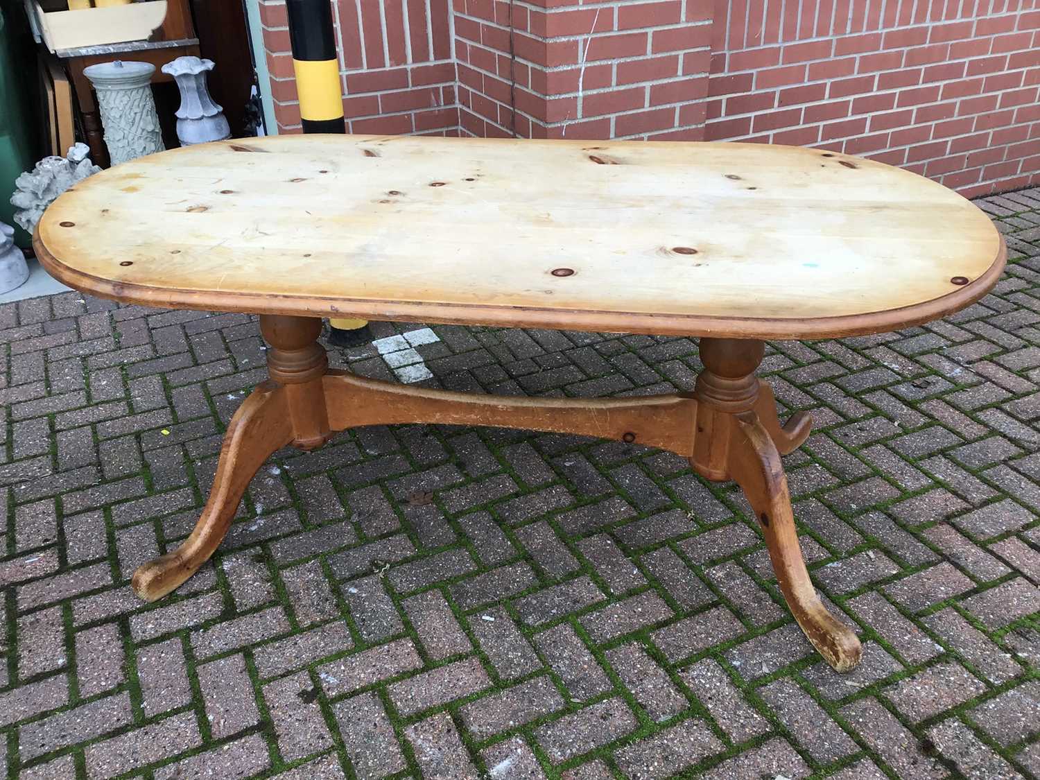Lot 87 - Pine kitchen table on twin pedestal base joined by stretcher